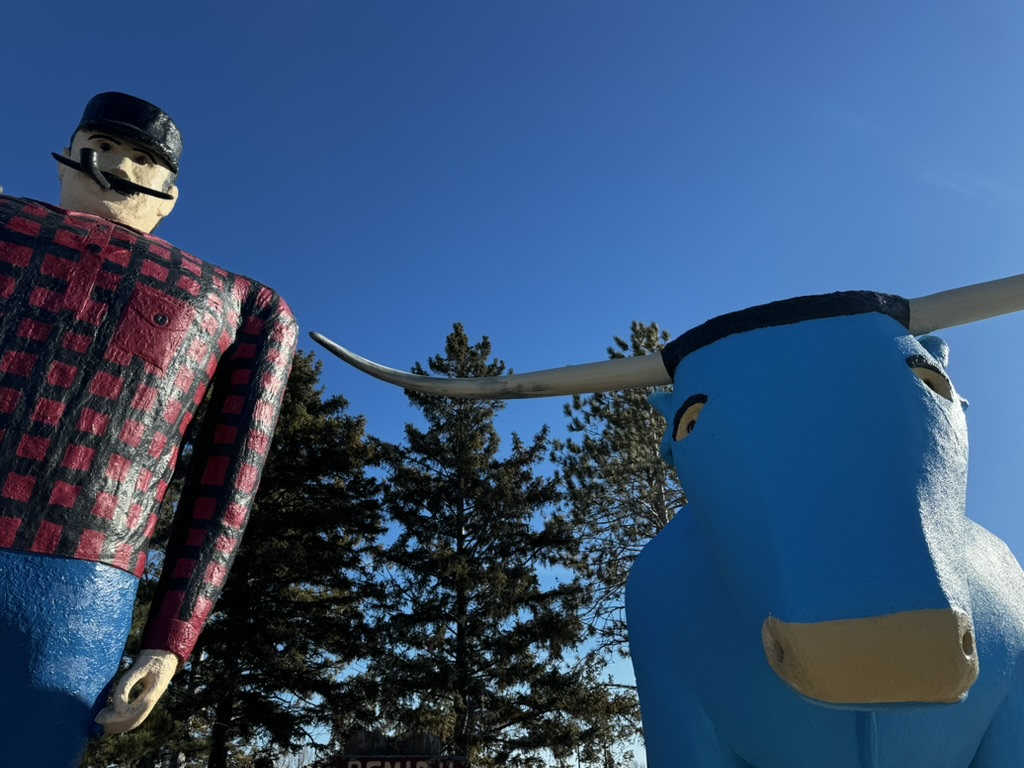 Babe the blue ox and Paul bunyon statues stand proudly against an almost-sunset backdrop